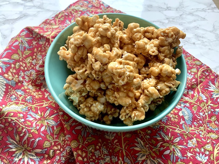 Blue bowl full of caramel popcorn