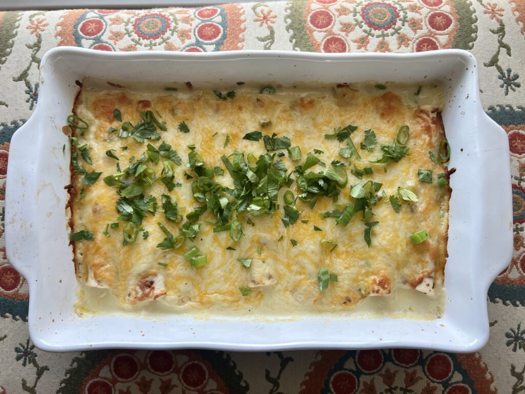 pan of creamy chicken enchiladas ready to serve