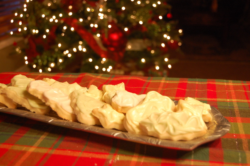 tray of shortbread cookies with the Christmas tree lights in the background