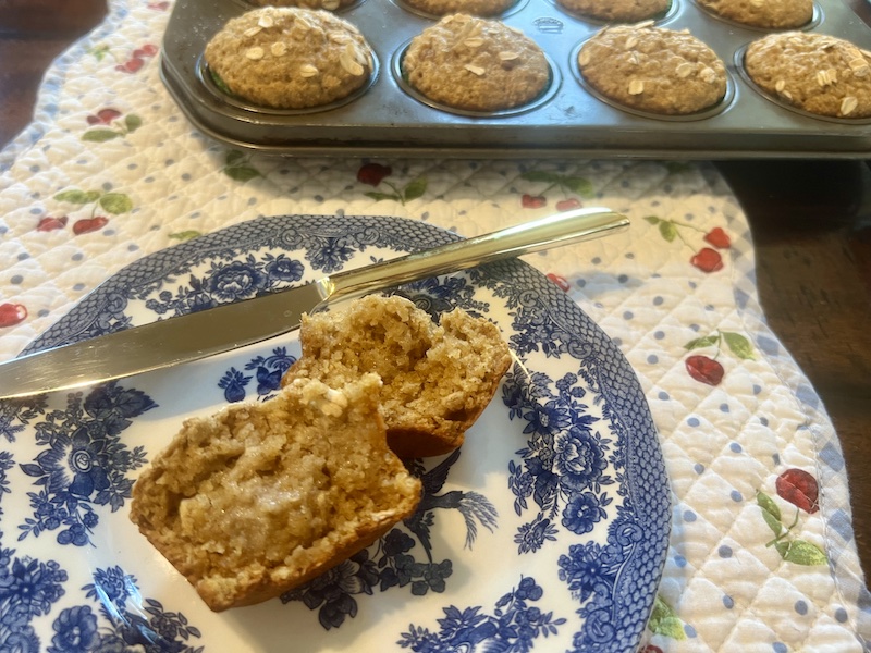 plate with a split and buttered applesauce oatmeal muffin
