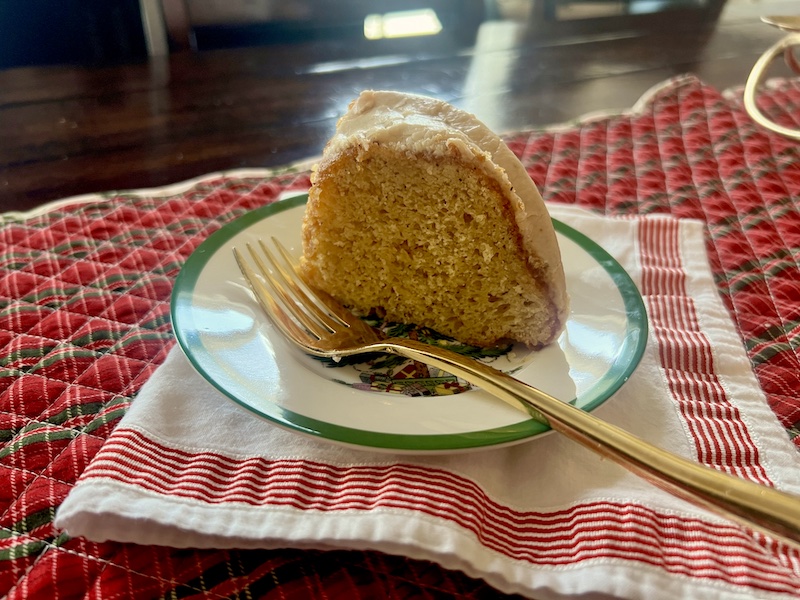 Eggnog Bundt Cake with Browned Butter Glaze slice on a small plate with a fork