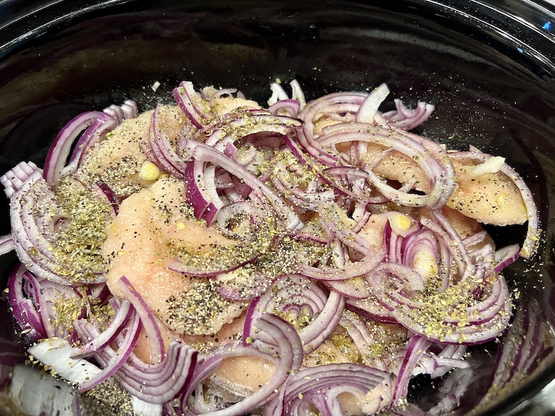 crock pot full of slow cooker (or Instant pot) Greek chicken ready to cook