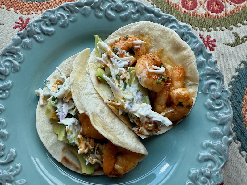 Honey Lime shrimp tacos on a blue plate